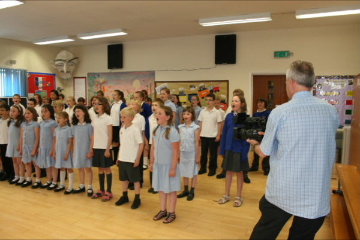 Filming the children singing